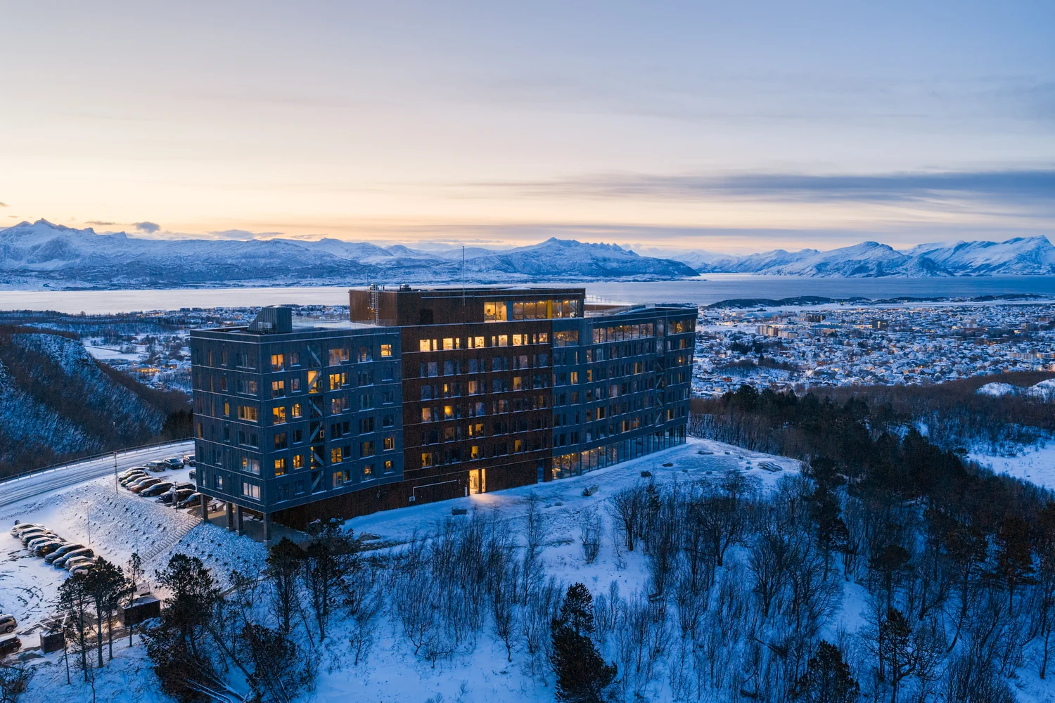 Aerial hotel image in a snowy mountain landscape at sunset Hotel in a snowy mountain landscape at sunset seen from above