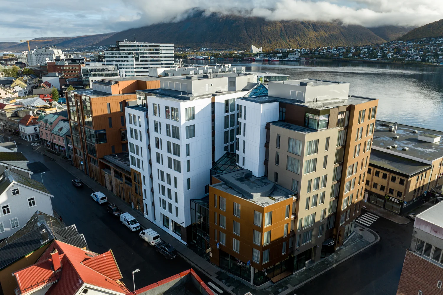 Drone perspective showing a centrally located hotel and its surroundings City hotel in a central location with views of water and mountains