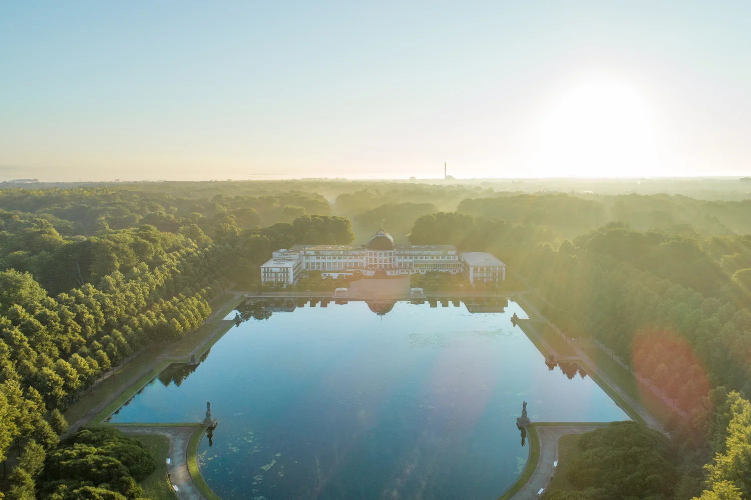 Bird's-eye hotel image highlighting landscape and property layout Hotel complex with park and water seen from a bird's-eye view