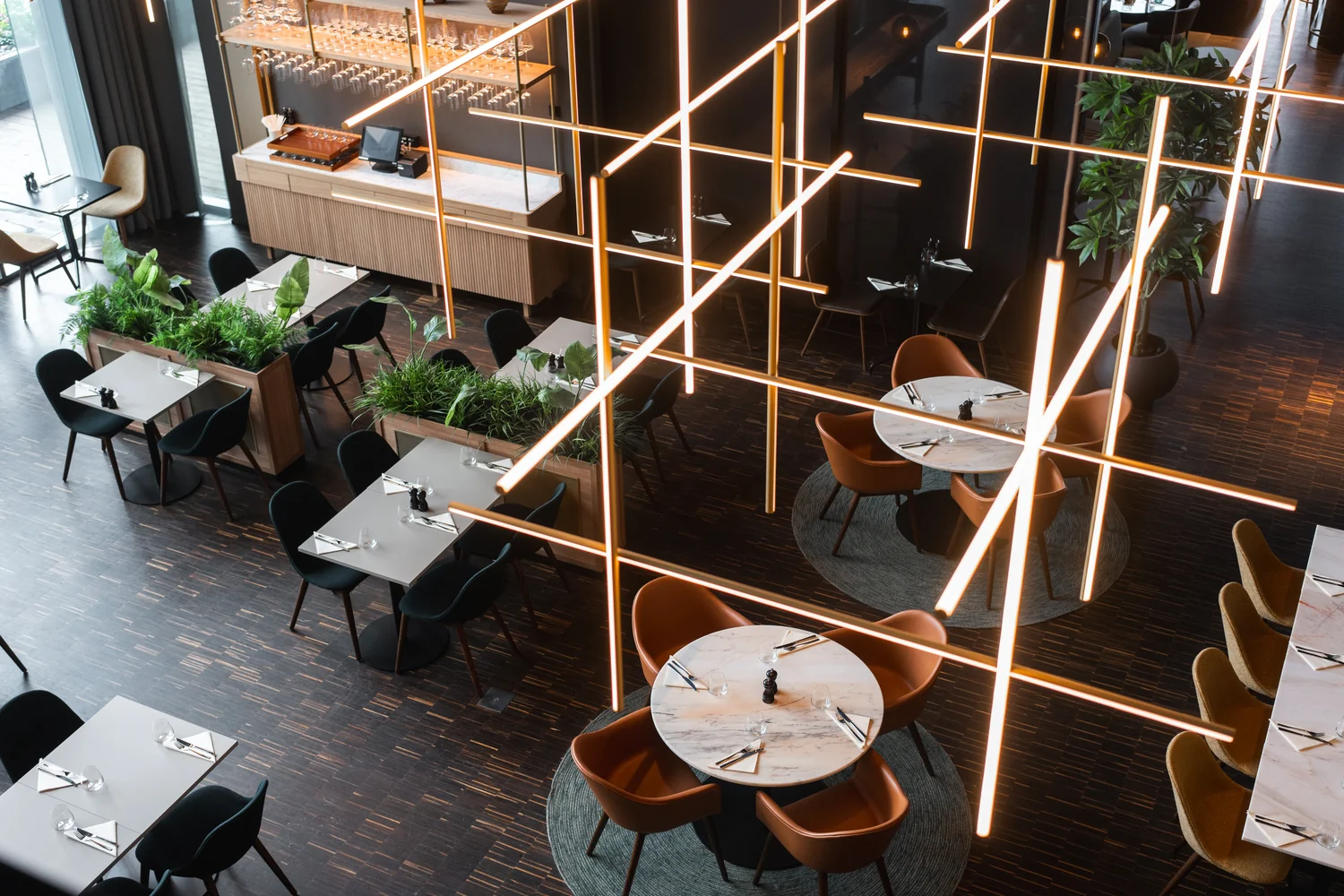 Hotel restaurant interior with elegant lighting and structured composition Modern hotel restaurant with design lighting, stylish seating areas and set tables