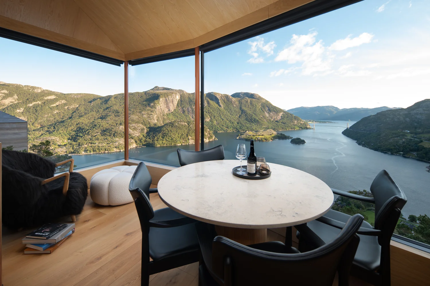 Exclusive hotel interior with panoramic view and calm visual balance Exclusive hotel interior with panoramic window and spectacular fjord view