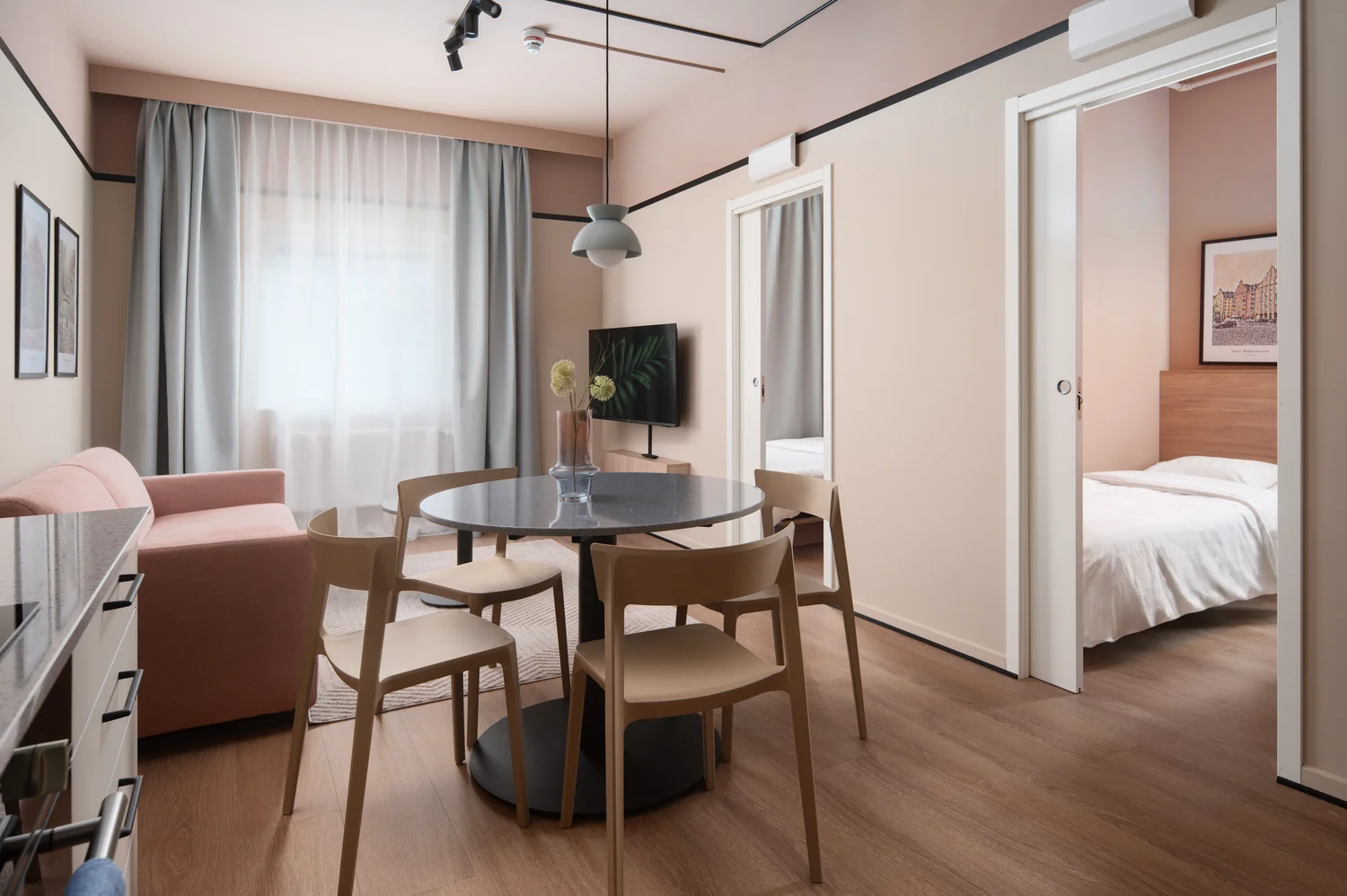 Spacious hotel apartment shown with clarity and visual structure Modern hotel apartment with dining area, living room and separate bedroom