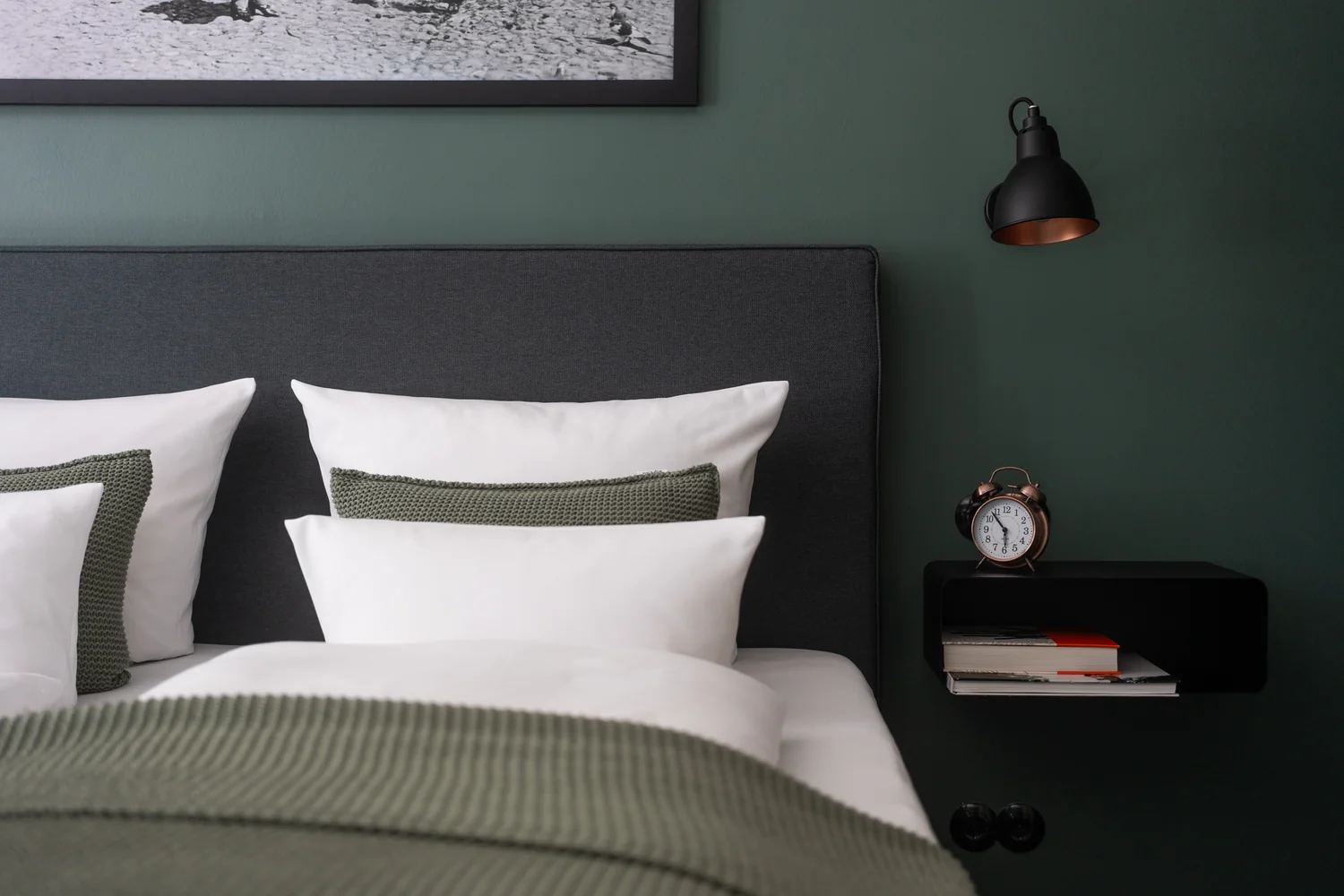 Close-up interior detail showing texture, materials and hotel comfort Stylish hotel room detail with double bed, premium textiles and modern bedside table