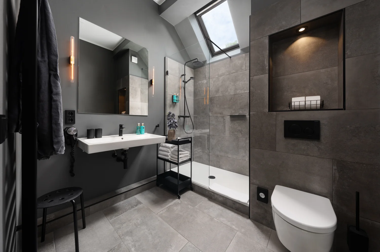 Contemporary bathroom scene with dark tiles and elegant lighting Modern design bathroom with dark tiles, shower and stylish lighting